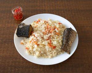 West African fonio with smoked fish and spicy onion sauce for traditional African food visuals