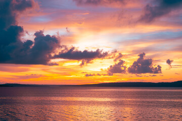 Twilight over sea with warm sunset glow, soft pastel sky, and peaceful ocean surface.