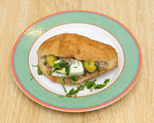 Moroccan tuna sandwich with hard-boiled egg and olives for traditional street food concepts
