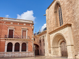 Fototapeta premium lmoina Square, or l’Almoina Square, with a view of the Arch of Barchilla street, the Archbishop's palace and a gate of the Cathedral called Almoina Gate or Palau Gate. Valencia, Spain, Europe