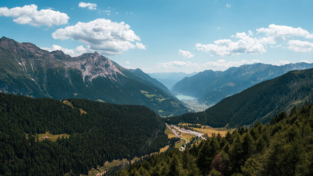 breathtaking panoramic view of Poschiavo valley and lake from Alp Grum in Swiss Alps.