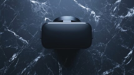 A black VR headset sits on a dark marble surface.