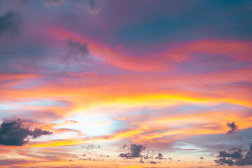Sunset sky transitions from deep blue to fiery orange and pink in a peaceful evening scene.
