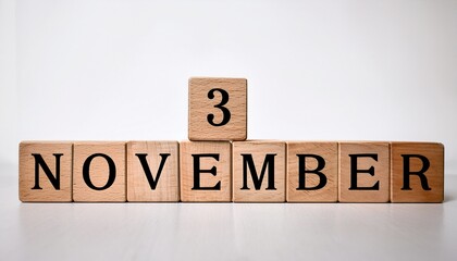 Fototapeta premium Minimalist photo of wooden blocks with date 3 November. Day and month, calendar on white background