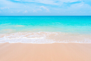 Beautiful beach with turquoise water, white sand, and small waves. Summer holiday concept.