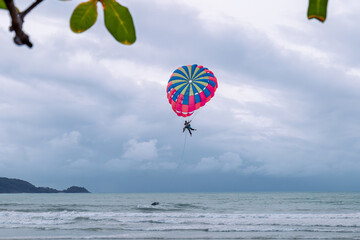 Phuket Patong, Thailand - 09.03.2023: people paragliding on Patong Beach