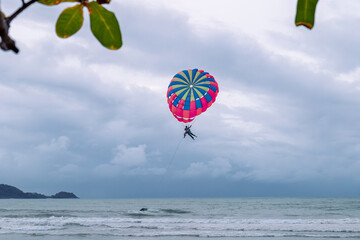 Phuket Patong, Thailand - 09.03.2023: people paragliding on Patong Beach