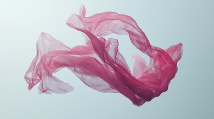 Flowing pink fabric suspended in mid-air creating an elegant visual during a serene moment