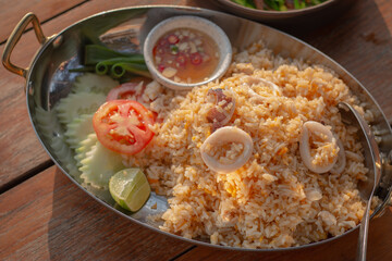 Top view of seafood fried rice served on wooden table