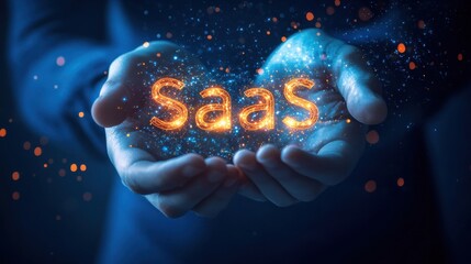 Businessman holding glowing saas acronym in his hands