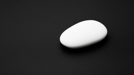 A white rock on a black background.