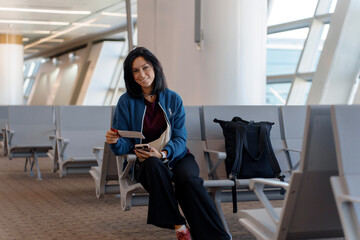Woman Waiting at Airport Gate with Boarding Pass and Smartphone in Hand - Life Moments of Travel in Departure Hall