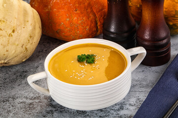 Vegan pumpkin cream soup served sesam