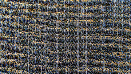 Dark texture of woven vinyl flooring with gold threads