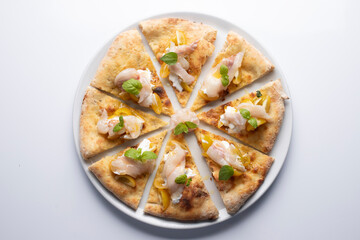 Pizza with raw fish and yellow pachino tomato