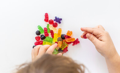 Child with jelly candies. Selective focus.