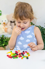 Child with jelly candies. Selective focus.