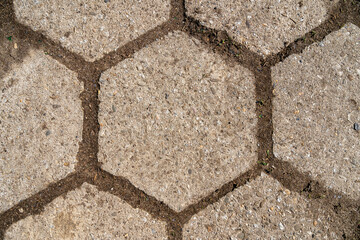 Old hexagonal concrete cubes on the road, as texture.