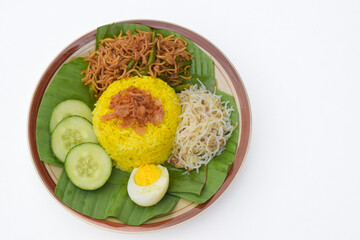 Nasi kuning or yellow rice or tumeric rice is a traditional Indonesian food, made from rice cooked with turmeric, coconut milkspices served with eggs, shredded fish, rice vermicelli, fried noodles.