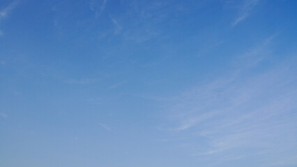 blue sky with fluffy thin clouds