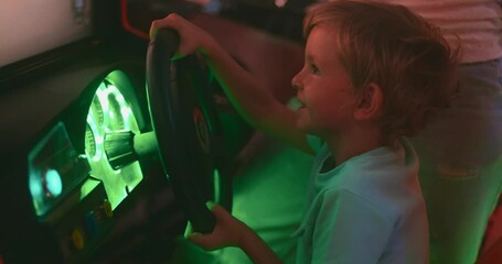 Happy child playing arcade racing game