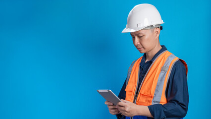 Confident young engineer wearing orange and a safety helmet stands holding a laptop, phone with various emotions.