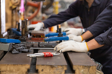 Factory engineers control machinery to produce quality zinc sheet metal.