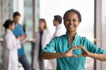 I love my work. Portrait happy smiling enthusiastic female doctor nurse in blue surgical scrubs...