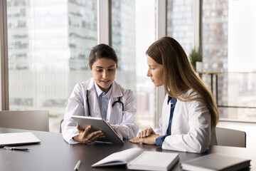 Interactive learning in medicine. Skilled millennial female doctor therapist physician mentoring...