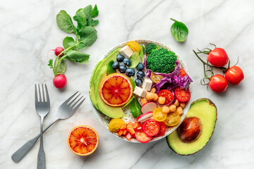 Buddha Bowl. Rainbow salad. Vegan poke bowl with avocado. Fresh and healthy food. Top shot with ingredients