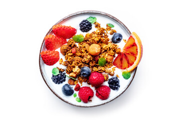 Granola with yogurt and fresh fruit. Organic gourmet muesli with strawberry, blueberry, mint, and orange, overhead flat lay shot on a white background