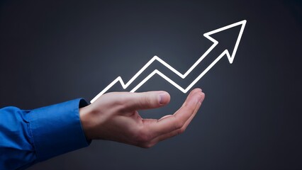 Hand presents an upward-pointing arrow. The image visually represents business growth, success, and financial upturn.

