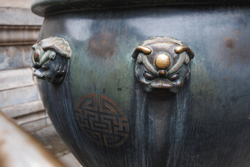 This image features a closeup view of a beautifully crafted pot that displays an intricate Chinese symbol on its surface, showcasing its artistic value