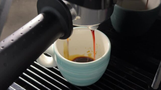 Small cup of espresso in a home coffee machine