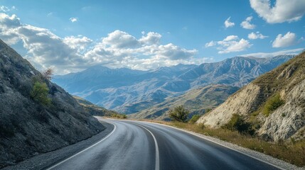 Naklejka premium Winding road through mountain scenery