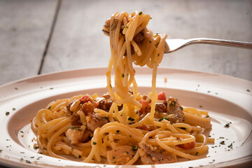 Eating spaghetti with pine nuts, raisin and mushroom