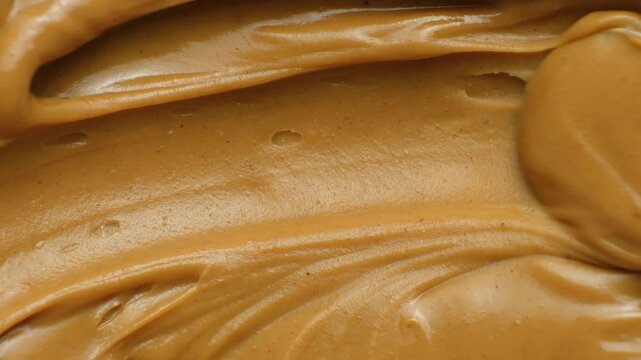Smooth Peanut Butter Texture. Overhead Food Background for Recipes or Ads