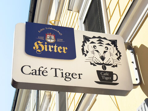 Caf&eacute; tiger sign with hirter logo mounted on exterior wall