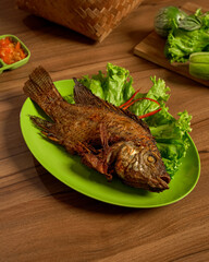 Golden Fried Freshwater Fish with Assorted Raw Vegetables and Sambal for a Flavorful Local...
