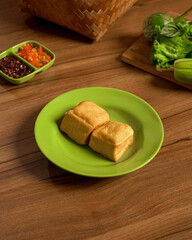Tofu Fried To Golden Perfection, Complemented With Fresh Vegetables And Spicy Sambal, A Staple In Indonesian Everyday Meals.