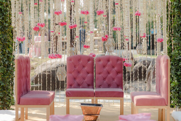 Romantic event setup with pink chairs and floral backdrop. Elegant and dreamy atmosphere. Perfect for a special celebration. #eventdecor #pinktheme