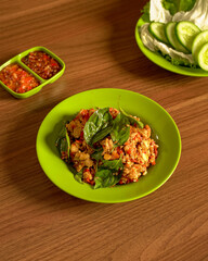 Smashed Tempeh Served With Fresh Vegetables And Spicy Sambal On The Side, A Flavorful And Rustic Sundanese Dish Full Of Texture And Taste.