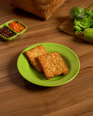 Indonesian Fried Tempeh Plate With Sambal And Fresh Greens, A Crunchy And Flavorful Meal From The Heart Of Sundanese Cuisine.
