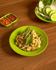 Trancam Salad with Assorted Fresh Raw Vegetables and Spicy Sambal on the Side, A Traditional Sundanese Culinary Delight Bursting with Natural Flavors.