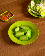 Steamed Pumpkin Served with Fresh Vegetables and Spicy Sambal on the Side, A Nutritious Traditional Indonesian Plant-Based Meal Option.
