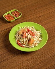 Stir-Fried Bean Sprouts with Anchovies Served with Spicy Sambal on the Side, A Traditional Indonesian Dish Rich in Flavor and Texture.
