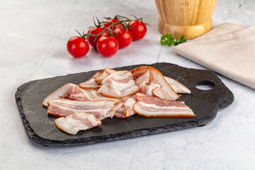 Raw pork tenferloin with bacon