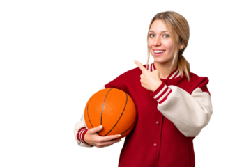 Young hispanic woman playing basketball over isolated white background pointing back