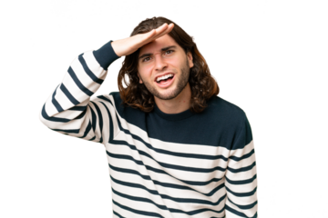 Young handsome man over isolated background looking far away with hand to look something