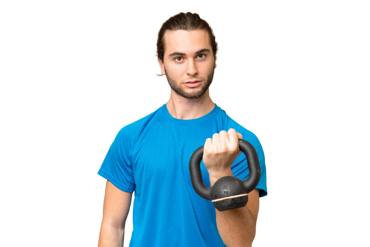 Young handsome man isolated on green chroma background making weightlifting with kettlebell